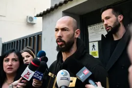 British-US former professional kickboxer and controversial influencer Andrew Tate (C) and his brother Tristan Tate (R) speak to journalists after their release from detention [Daniel Mihailescu/AFP]